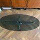 Table basse design ovale années 70 en verre fumé noir et pieds chromé