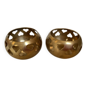 Pair of heart-shaped brass candle holders.