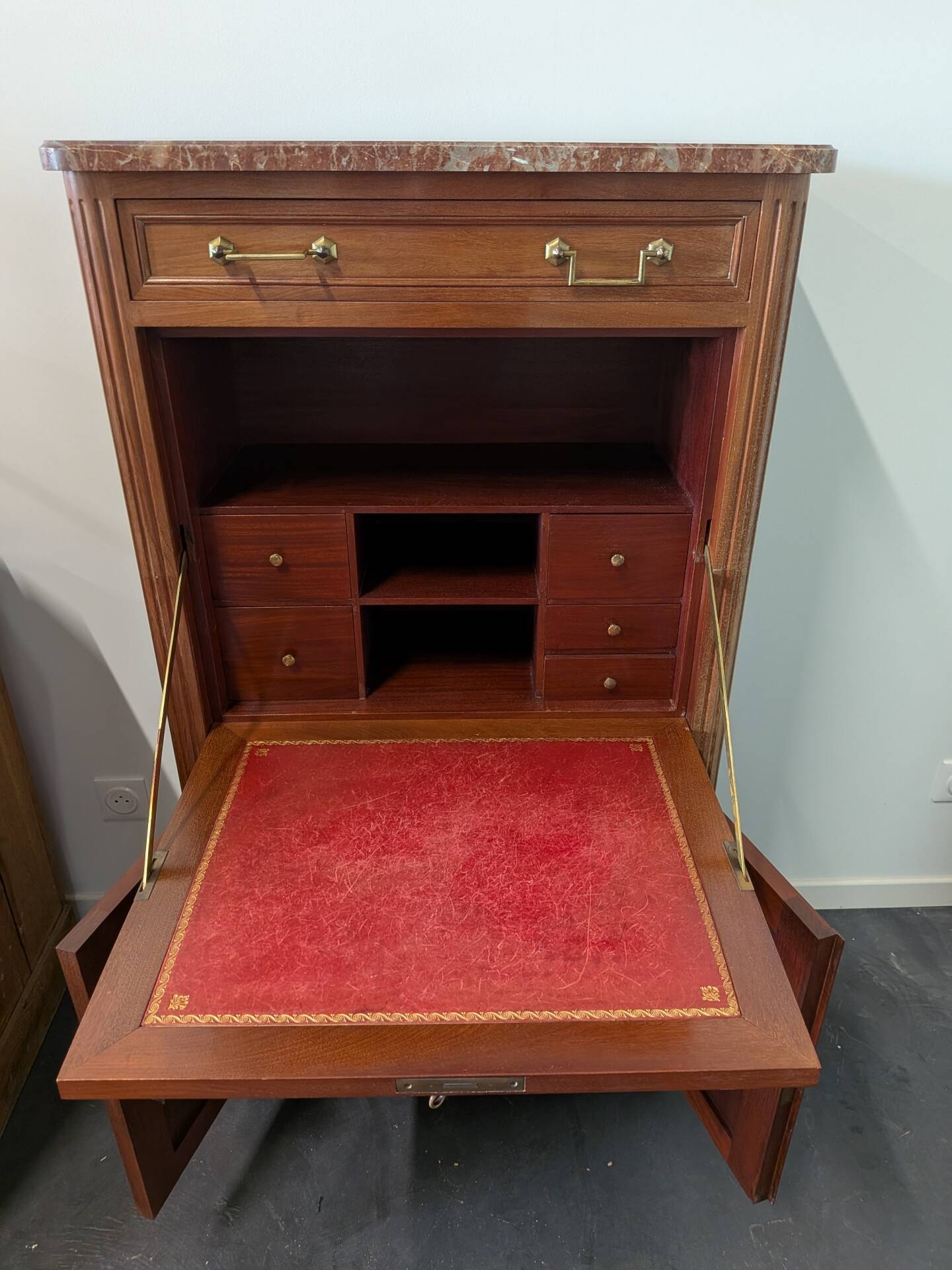 Secretary with a drop-leaf in Louis XVI style made of mahogany and royal red marble.