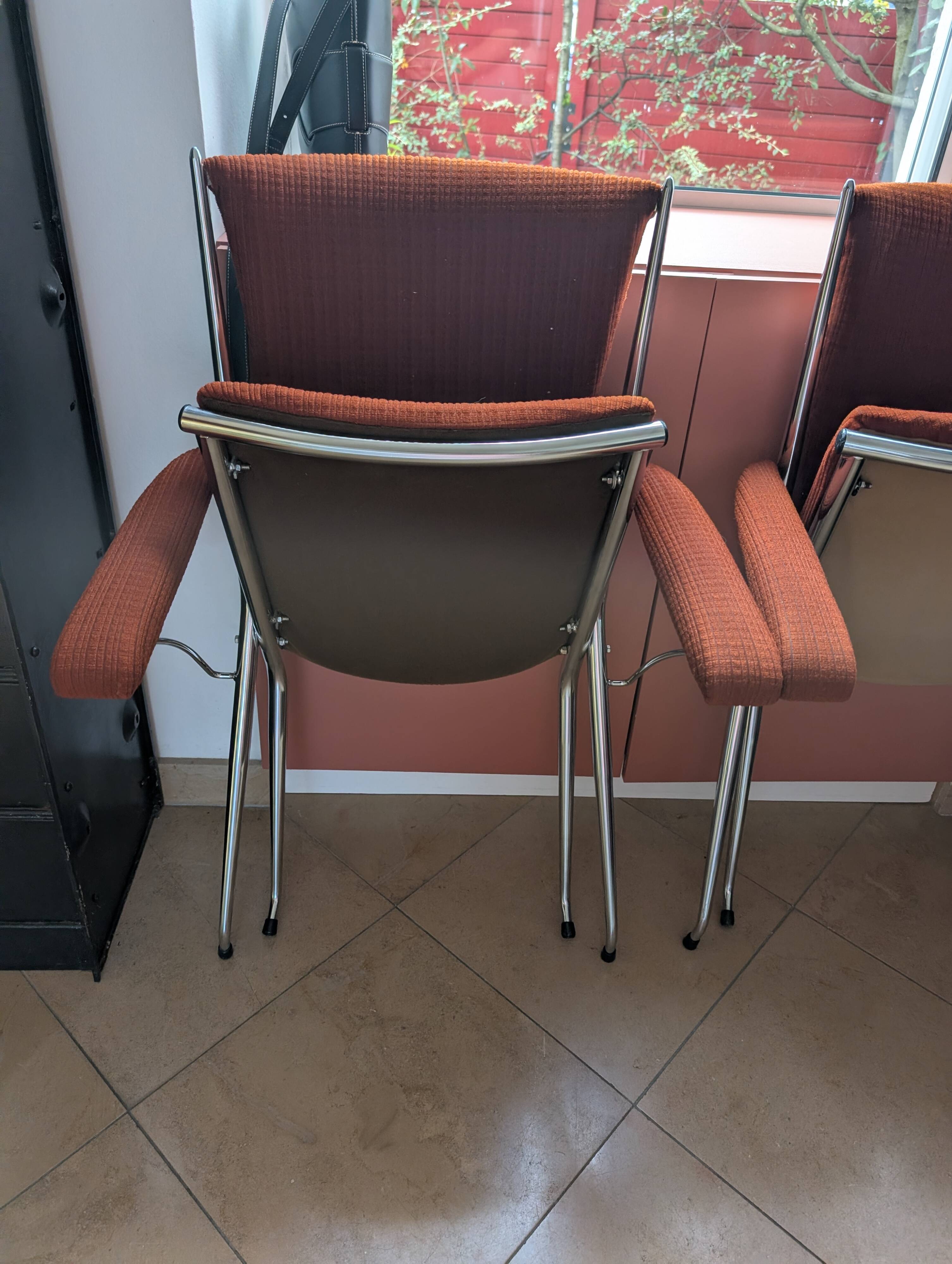 Pair of vintage folding chairs in terracotta fabric.