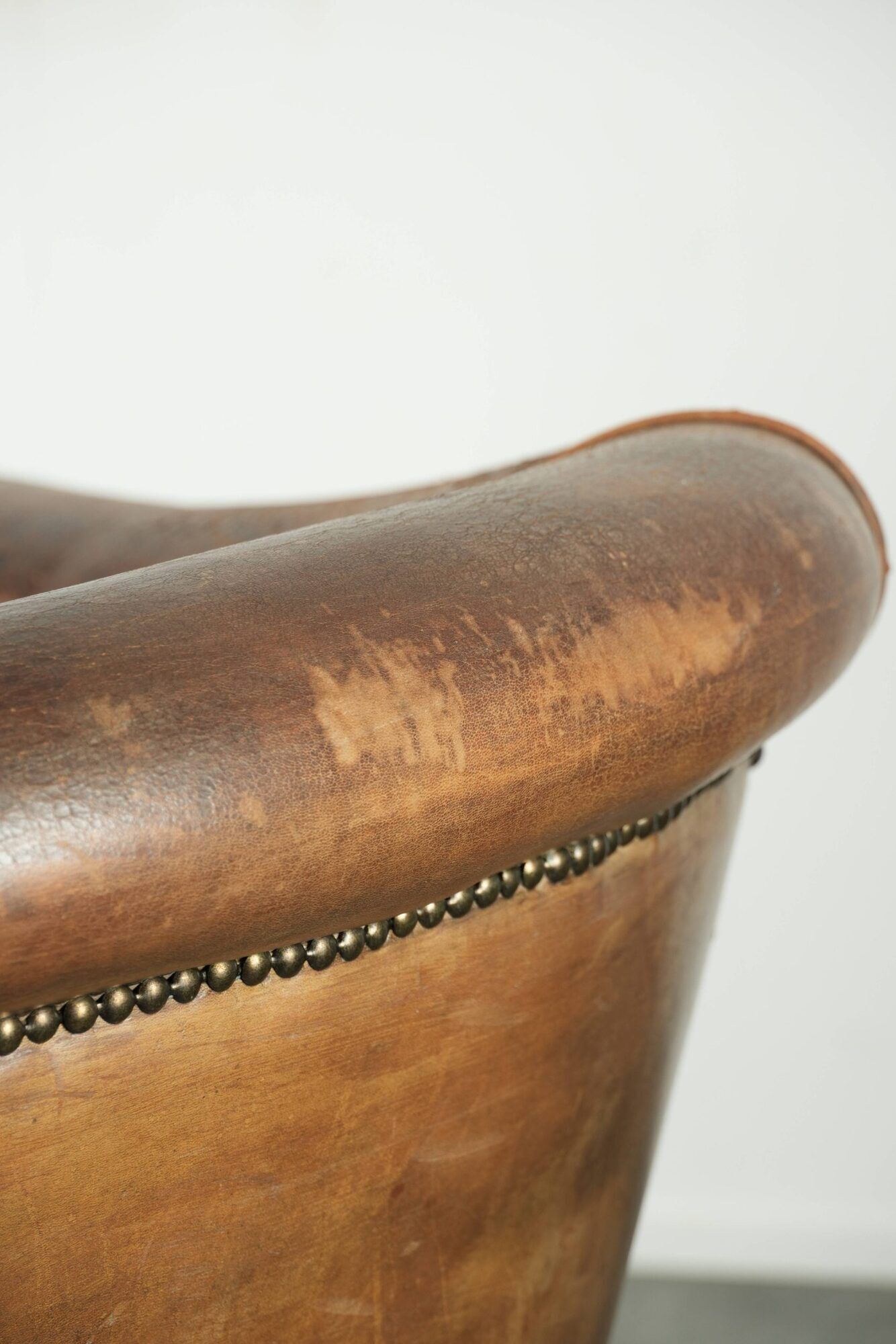 Vintage sheepskin club armchair finished with decorative nails