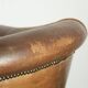 Vintage sheepskin club armchair finished with decorative nails