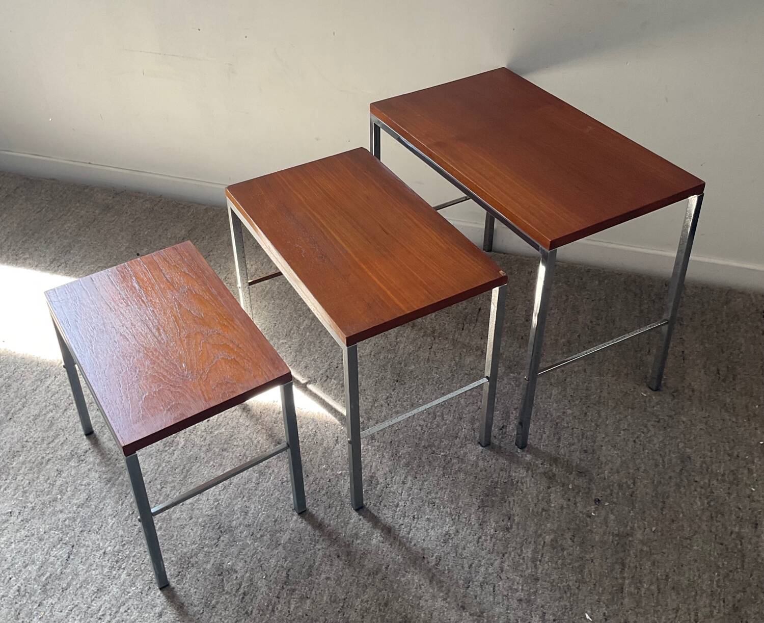 Trio of teak and chrome metal nesting tables from the 60s-70s