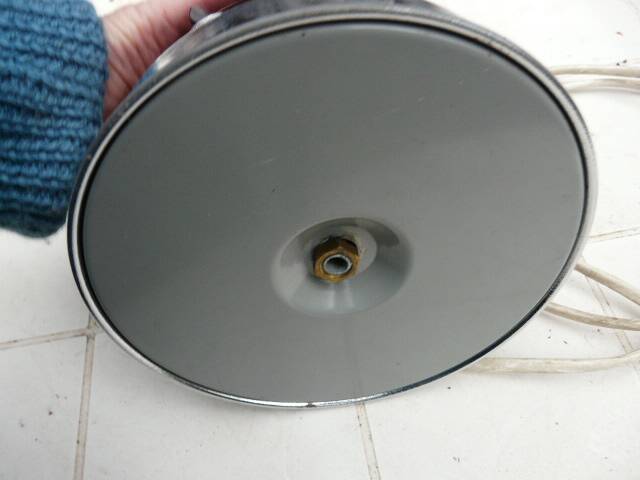 Red glass table lamp on a chrome base.