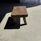 Small stool, rectangular solid teak side table with curved legs.