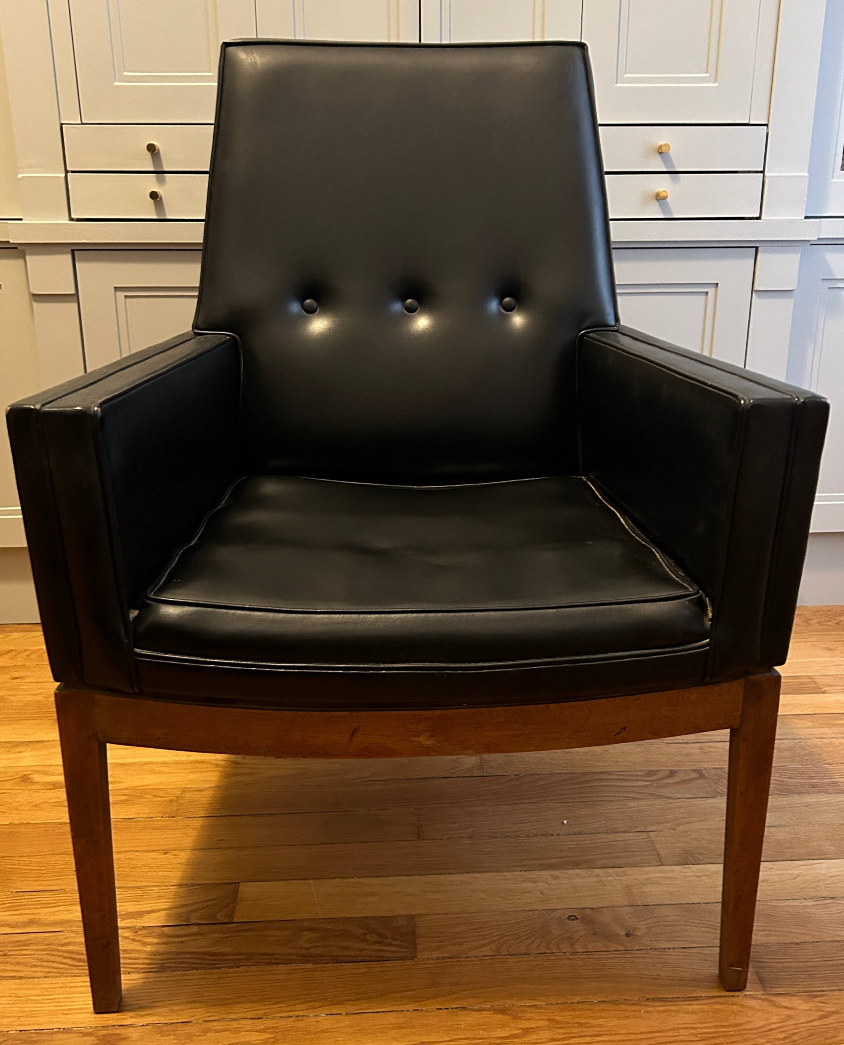 Modernist armchair in wood and black synthetic leather, circa 1960