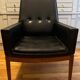 Modernist armchair in wood and black synthetic leather, circa 1960