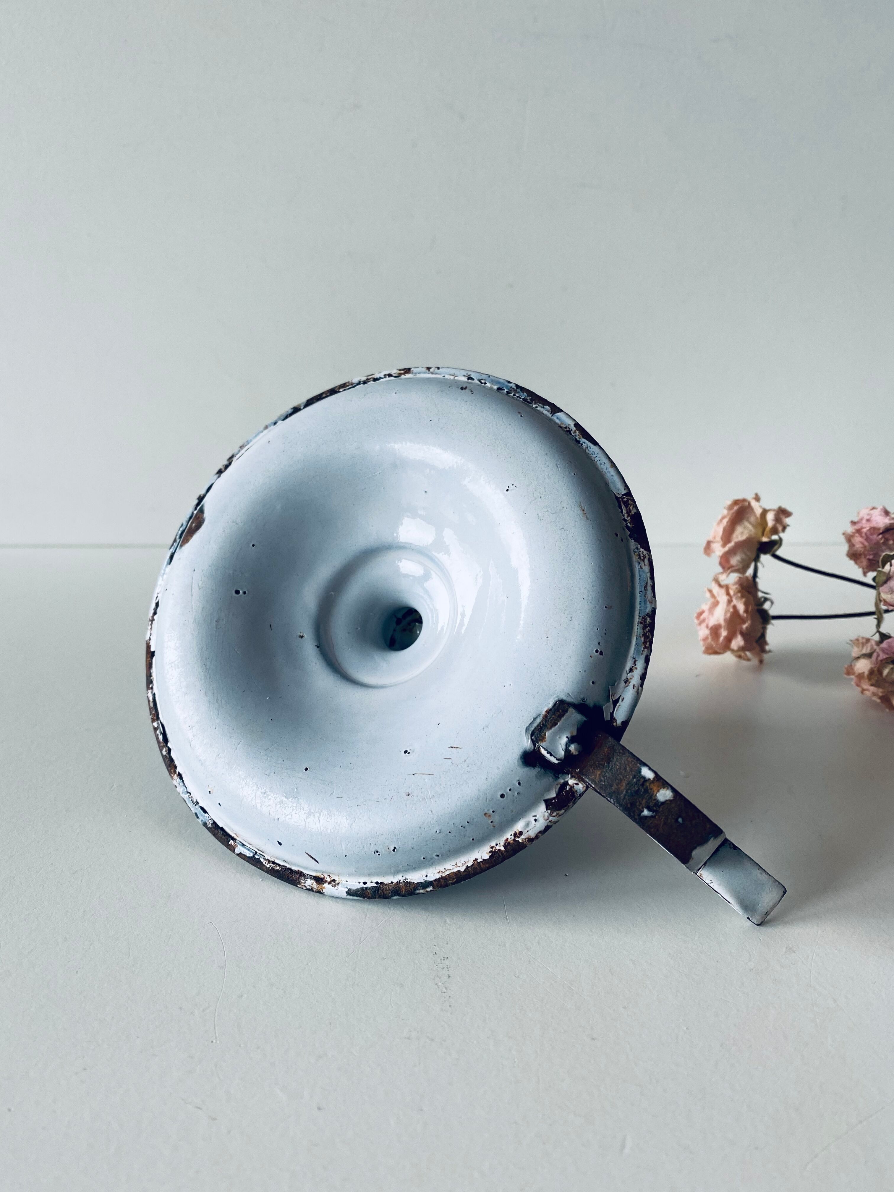 Old enamelled metal candlestick