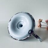 Old enamelled metal candlestick