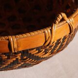 Woven patterned basket, made of straw and bamboo.