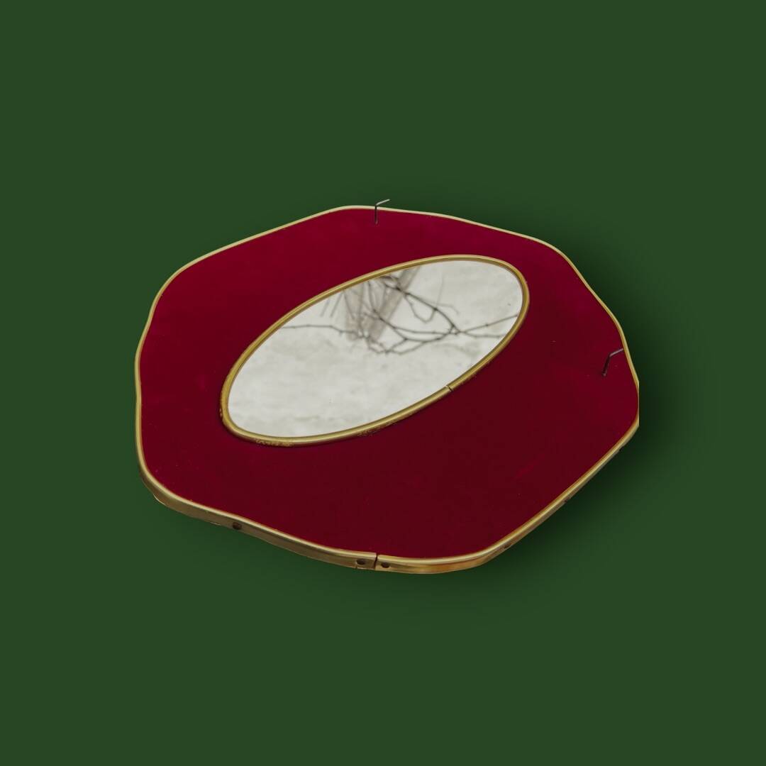 Oval wall mirror in burgundy velvet and brass – 1950s–1960s
