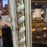 Miroir patiné beige avec des têtes de femme