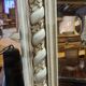 Beige patinated mirror with women's heads