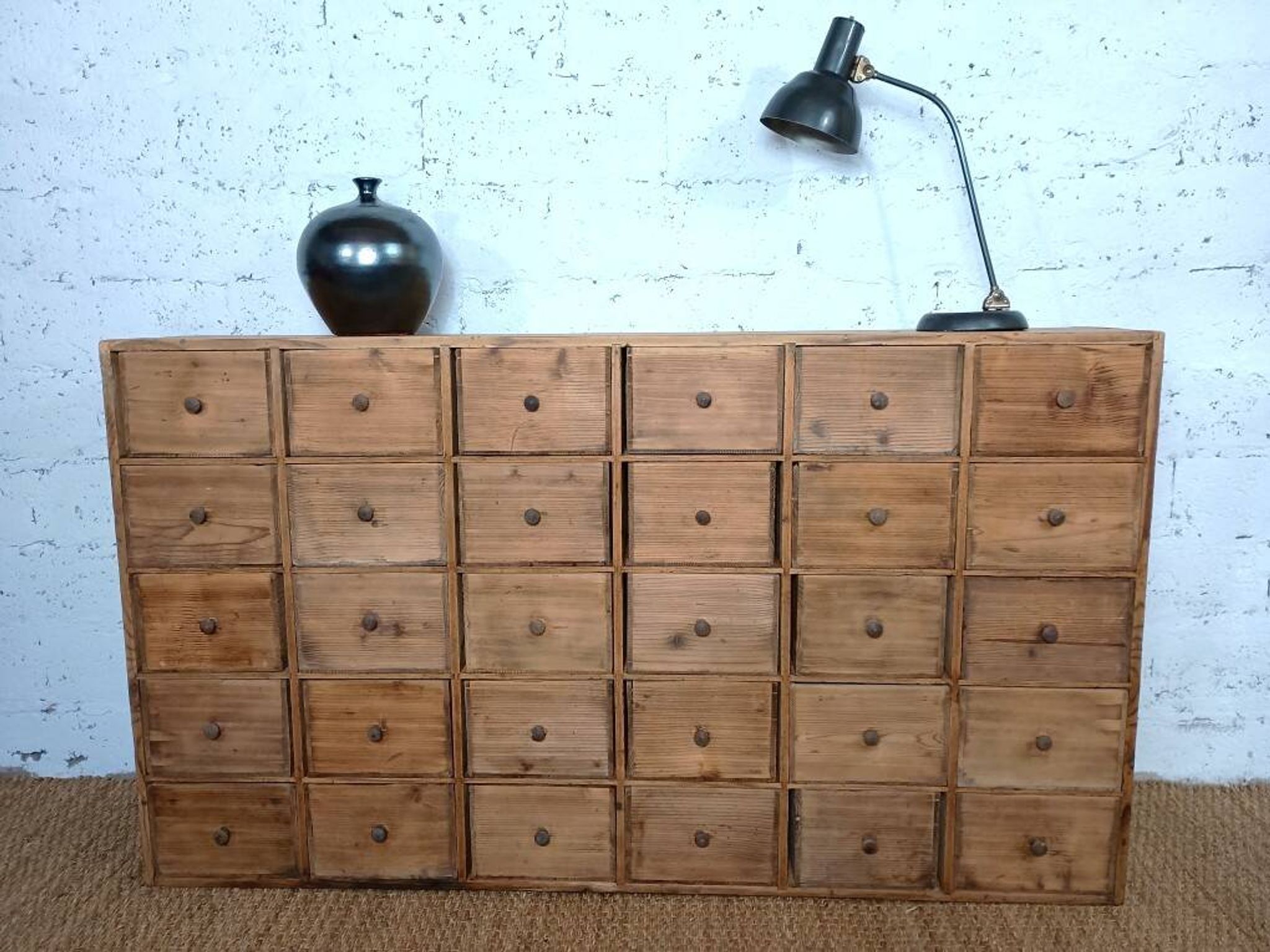 Industrial or apothecary workbench with 30 vintage wooden drawers.