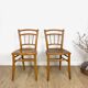Pair of curved wood bistro chairs and studded and perforated seat