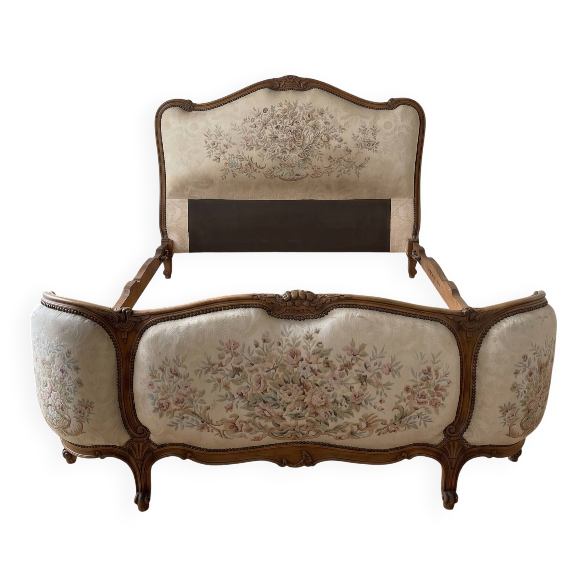 Double bed in Louis XVI style made of wood and floral fabric.