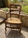 Antique Provençal armchair in wood with a straw seat.