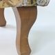 Large vintage upholstered footstool with curved legs.