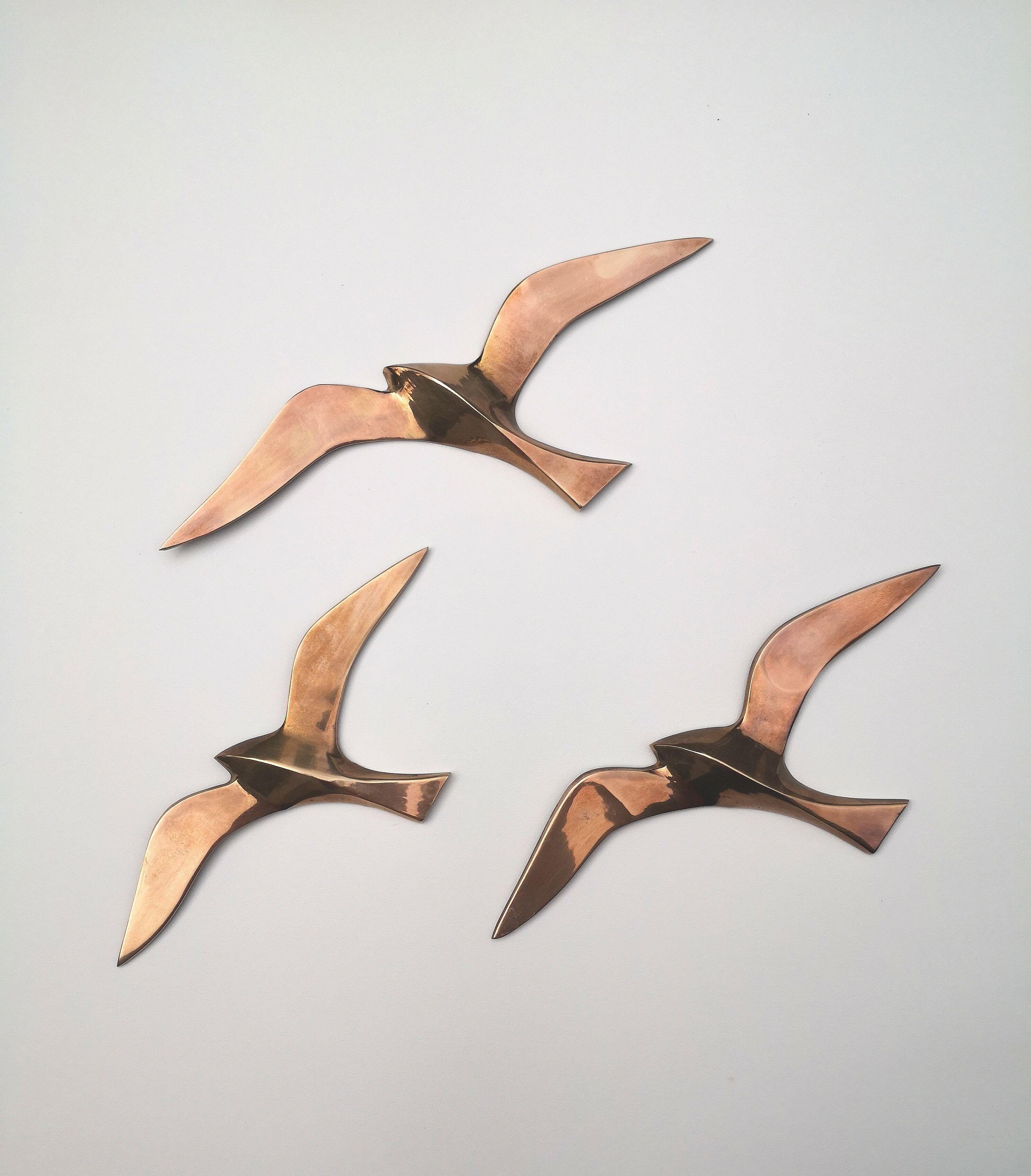 Birds stylized in brass