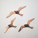 Birds stylized in brass