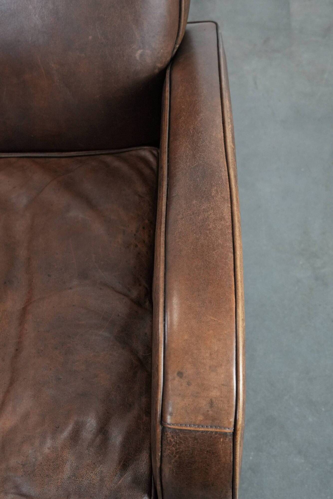 Elegant set of two sheepskin leather armchairs with beautiful round shapes