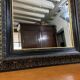 19th-century mirror Napoleon III in blackened wood on a gold background.