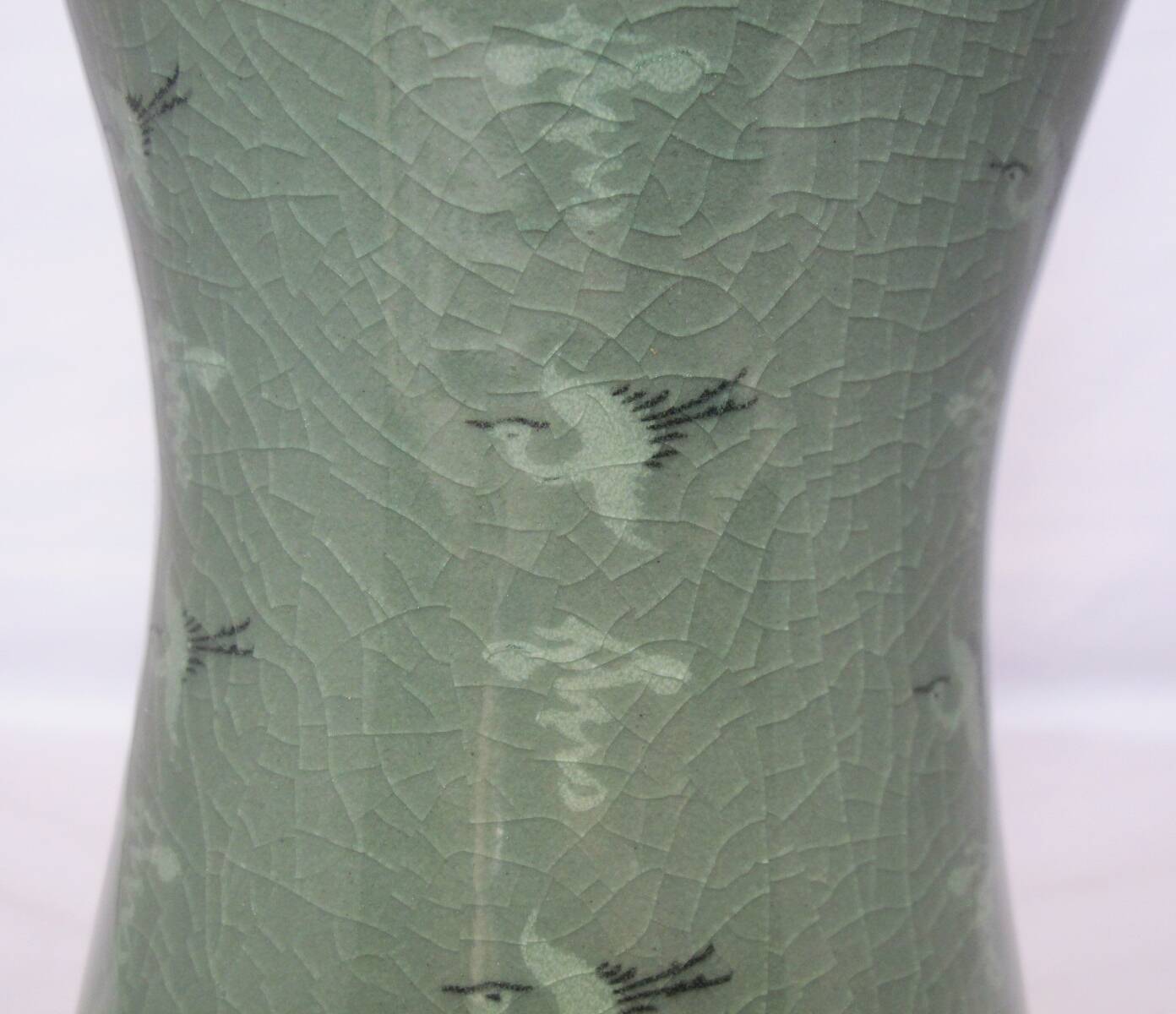 Korean vase in crackled celadon with a pattern of ducks and clouds.