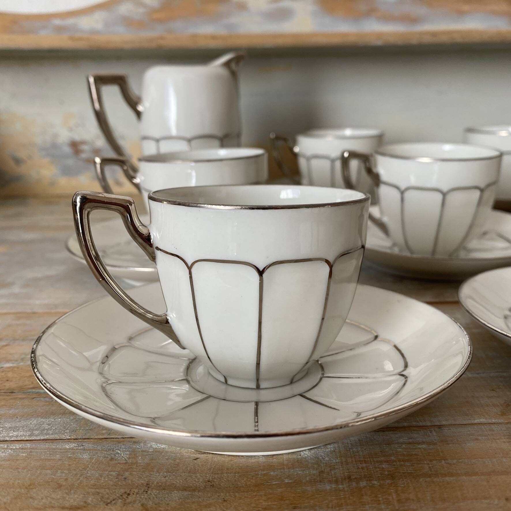 White and silver Limoges porcelain coffee cups and saucers.