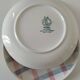 Two dessert plates Moulin des Loups with a pink and grey tablecloth design.