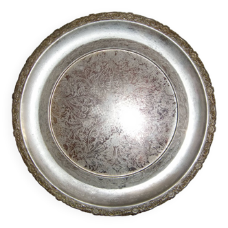 Large silver metal tray raised by a central foot