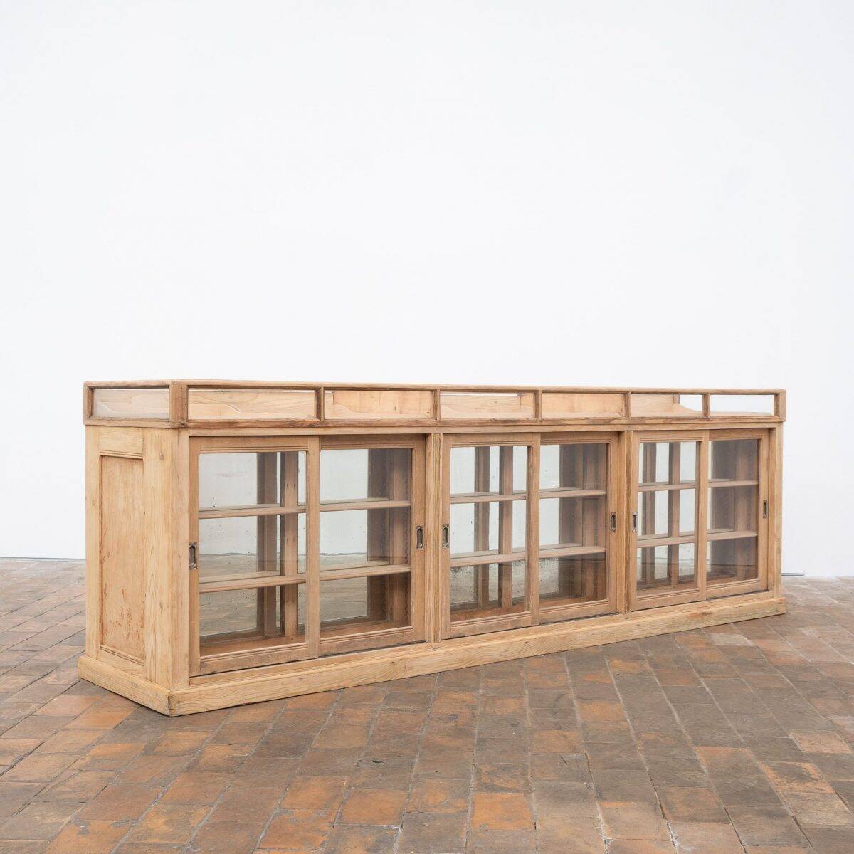 Old glass-fronted pine trade counter - early 20th century