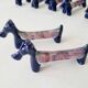 Set of 8 vintage ceramic knife rests, retro dog design.