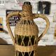 Braided wicker green bottle