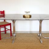 Dining table with smoked glass top and chrome base.