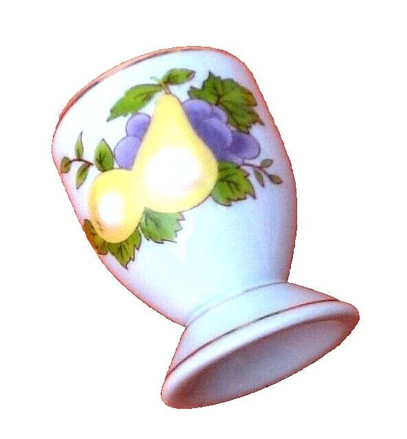 White porcelain egg cup decorated with pears / grapes.