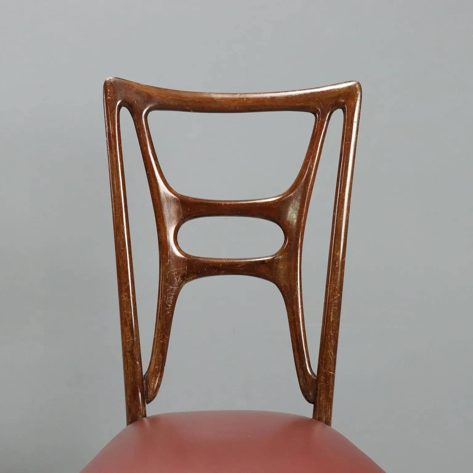 Set of six 1950s chairs with burgundy seats.