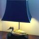 Lamp with brass duck on lacquered wood base
