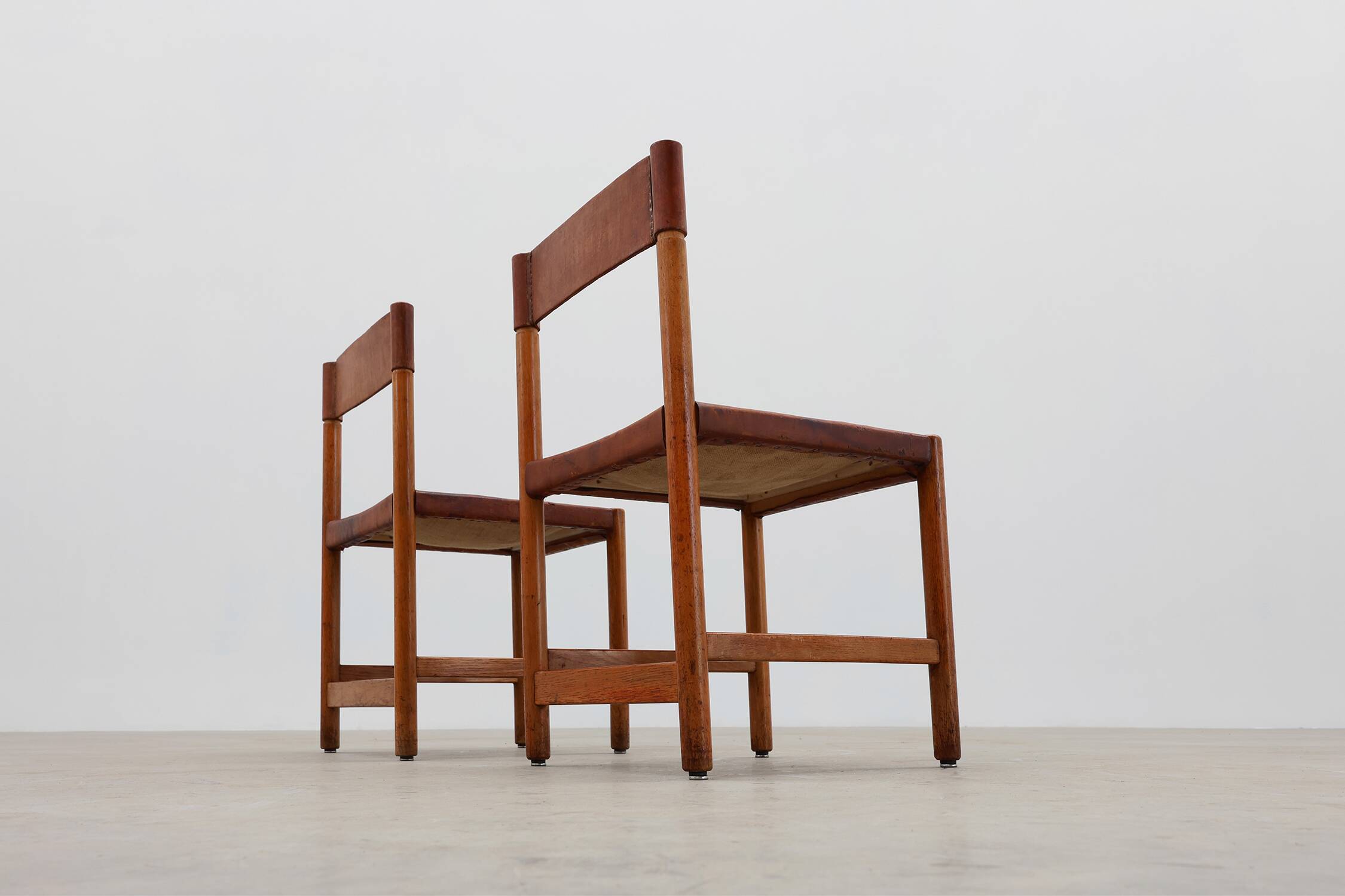 Pair of wood and leather Spanish chairs by Jordi Vilanova, ca. 1960