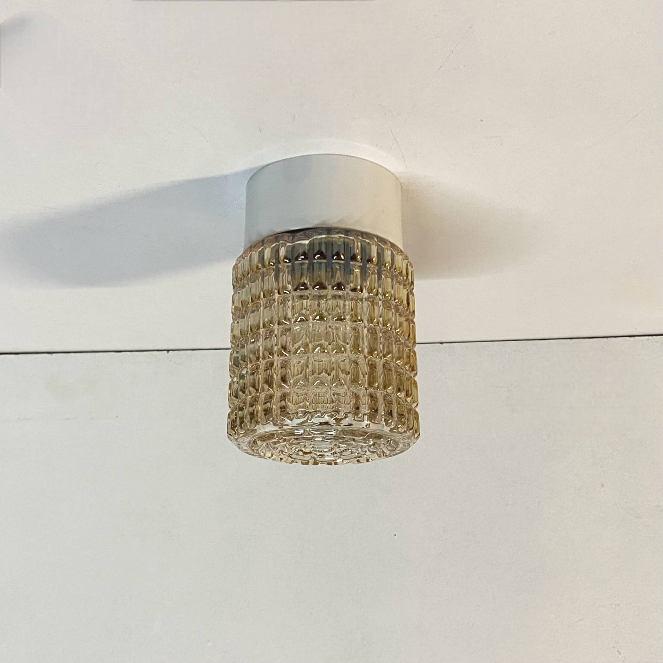 Old wall light in amber glass and plastic fixing base 1970
