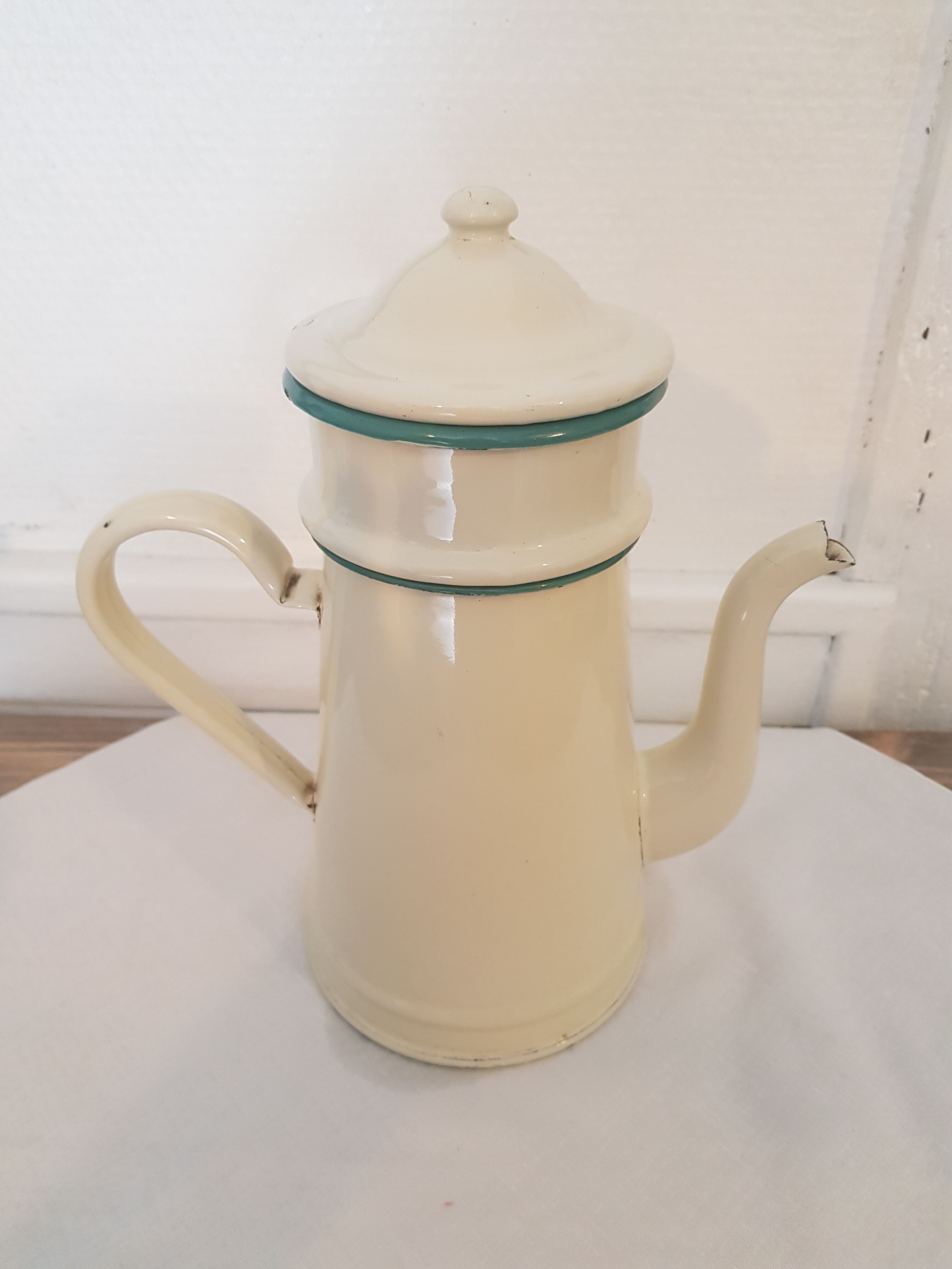 Old pale yellow enamelled coffee maker with filters