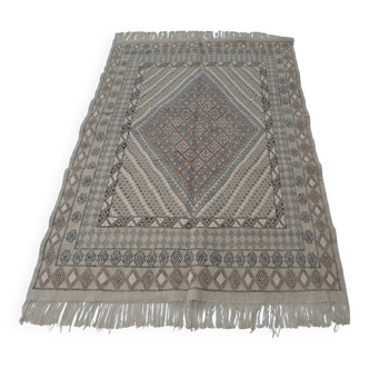 Traditional handmade Berber carpet in brown and beige wool.