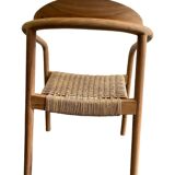 Solid wood chair with woven seat and armrests