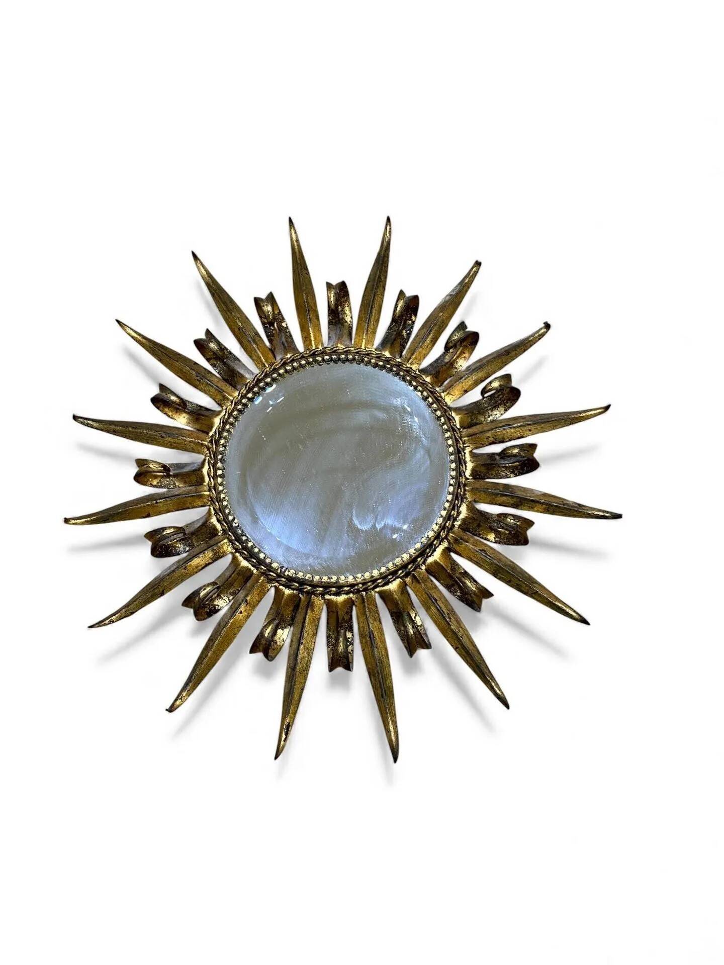 Golden and patinated metal sun mirror