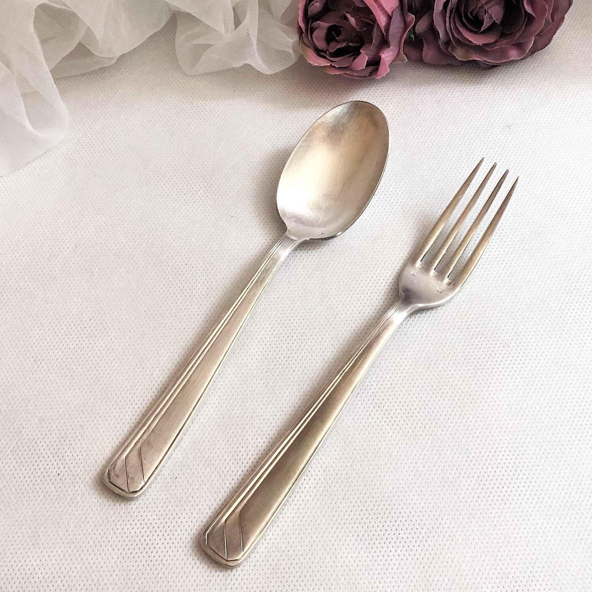 Set of 2 silver metal cutlery with punches