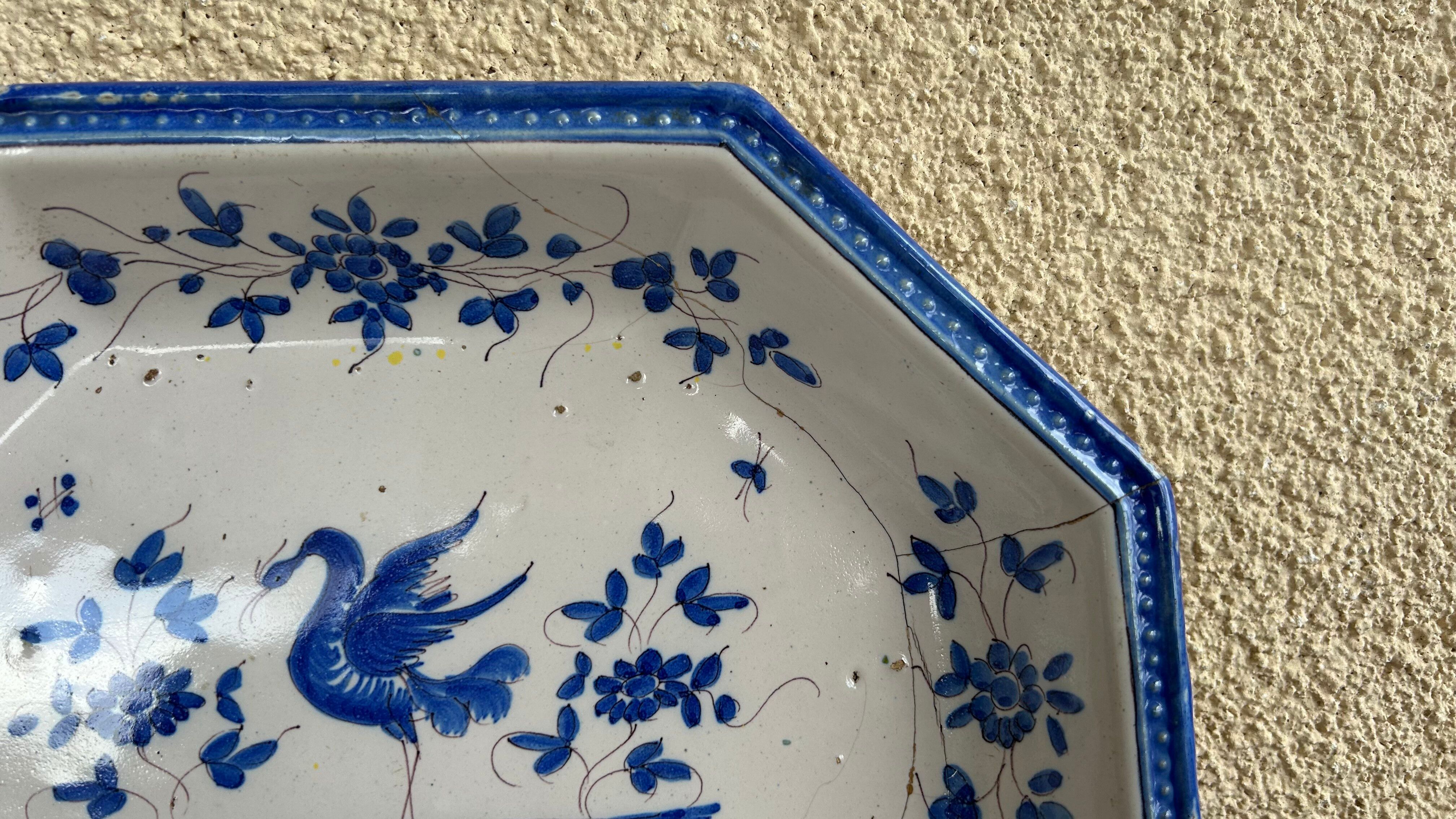 Antique octagonal plate in blue and white pottery with bird decoration.