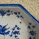 Antique octagonal plate in blue and white pottery with bird decoration.