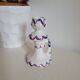 Ceramic candlestick with red and blue decoration.