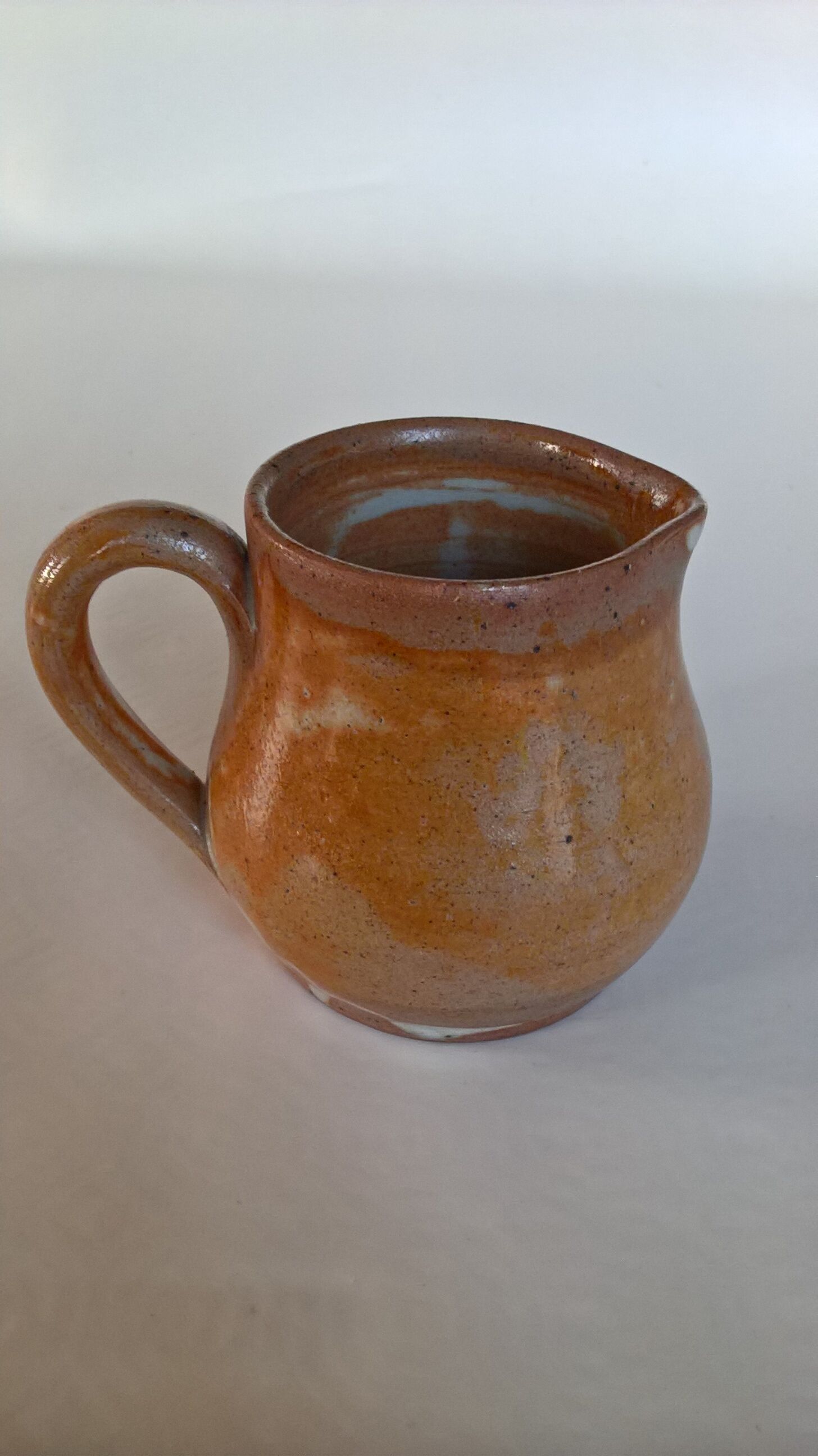 Creamy milk pot in sandstone