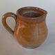 Creamy milk pot in sandstone