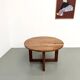Modernist round table in solid elm, crossed legs.